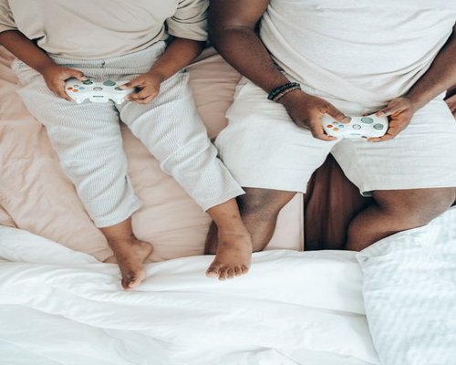 Family playing video games together in a lounge